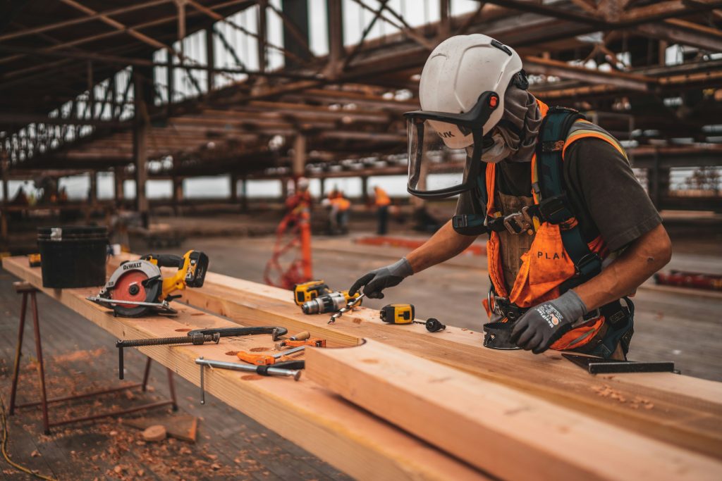 A carpenter working in a warehouse